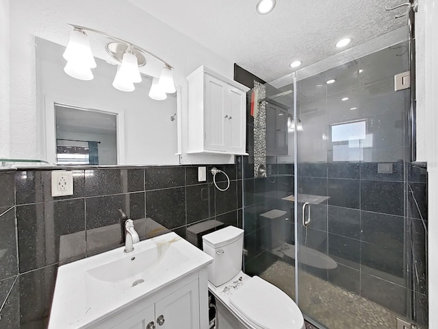 bathroom with vanity, toilet, an enclosed shower, and tile walls