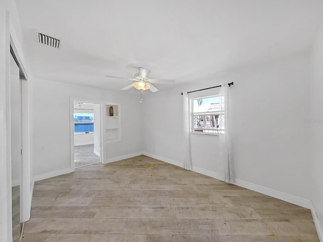 empty room featuring light wood-type flooring and ceiling fan