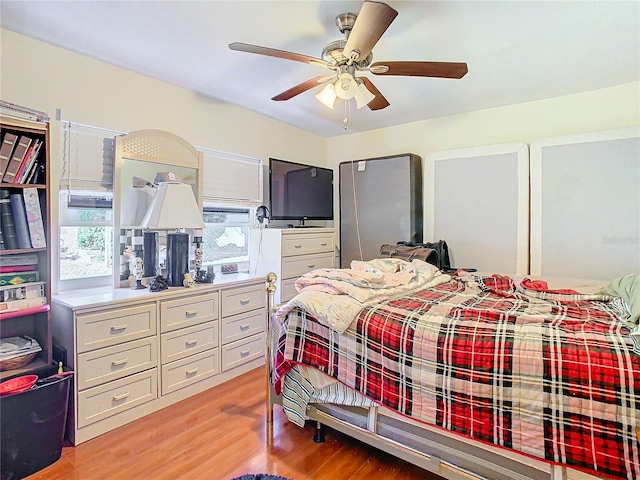 bedroom with light hardwood / wood-style flooring and ceiling fan