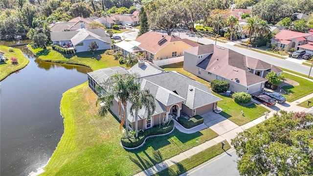 drone / aerial view featuring a residential view and a water view