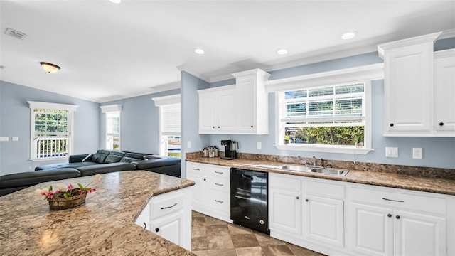 kitchen featuring black dishwasher, white cabinetry, and a wealth of natural light