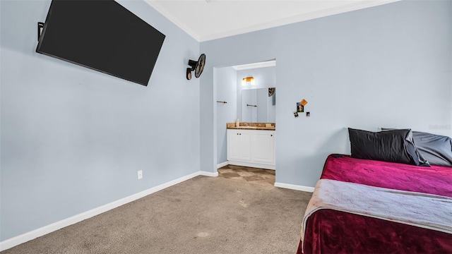 carpeted bedroom featuring ensuite bathroom and ornamental molding