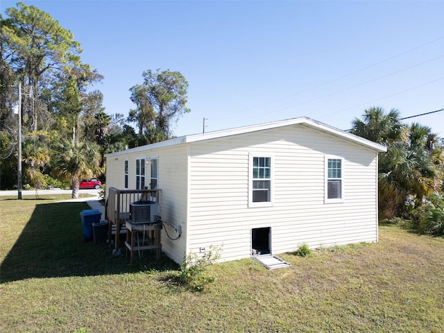 view of property exterior featuring a yard and central AC