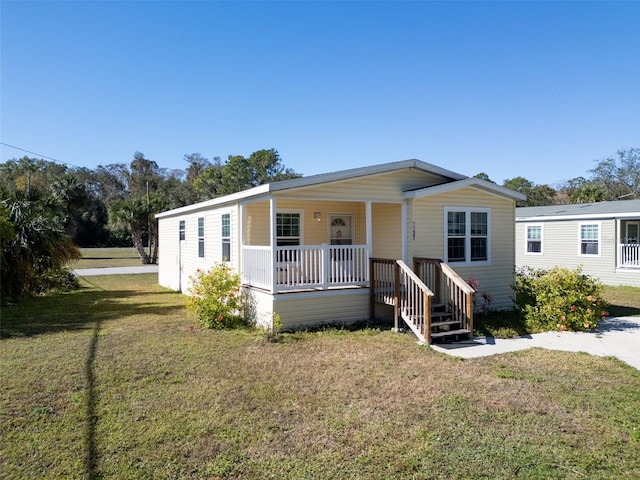 manufactured / mobile home with a porch and a front yard