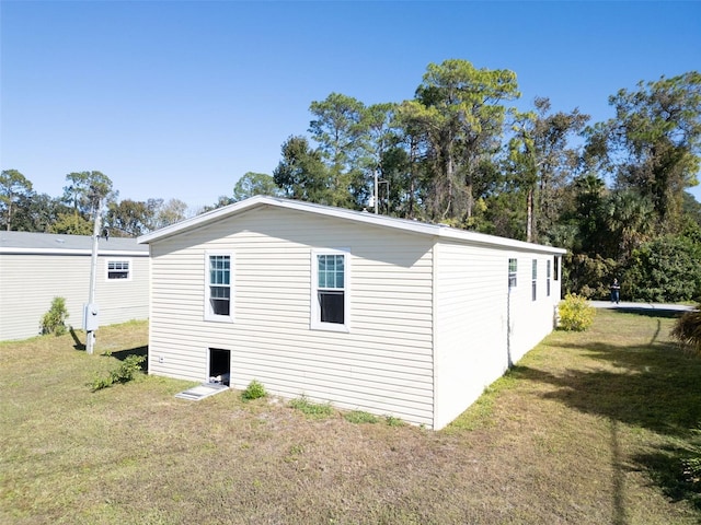 view of side of home featuring a yard