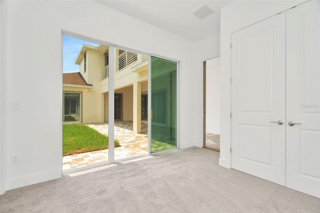 unfurnished room featuring light colored carpet