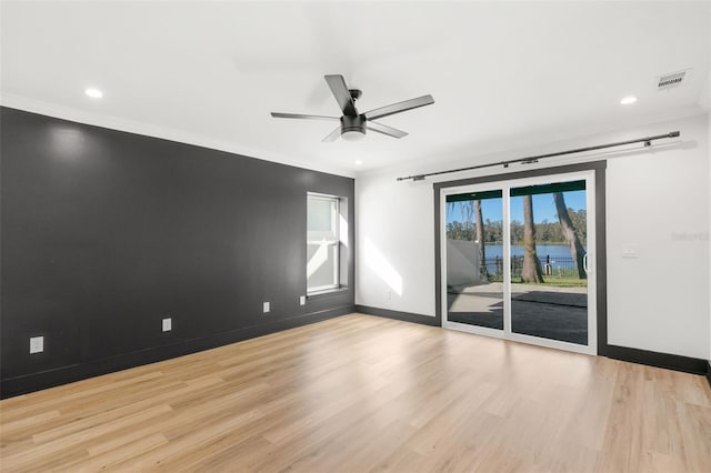 unfurnished room featuring ceiling fan, light hardwood / wood-style floors, and ornamental molding