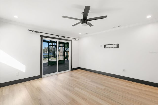 empty room featuring ceiling fan, light hardwood / wood-style flooring, and ornamental molding