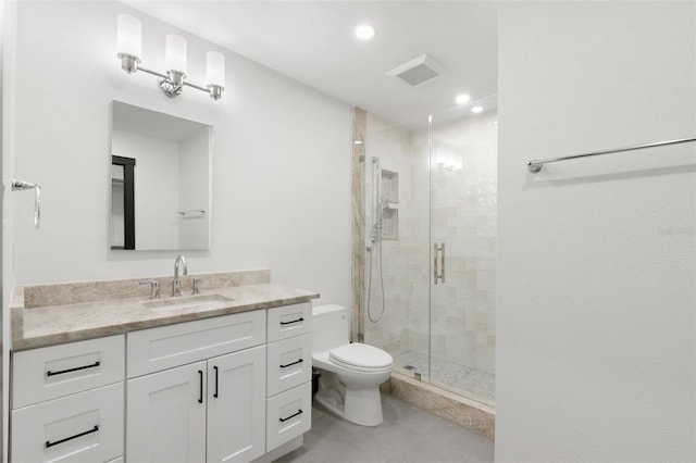 bathroom featuring tile patterned floors, a shower with door, vanity, and toilet