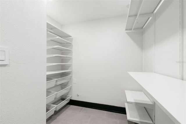 spacious closet featuring light tile patterned floors