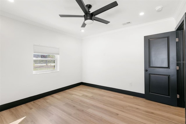 empty room featuring ceiling fan, light hardwood / wood-style floors, and ornamental molding