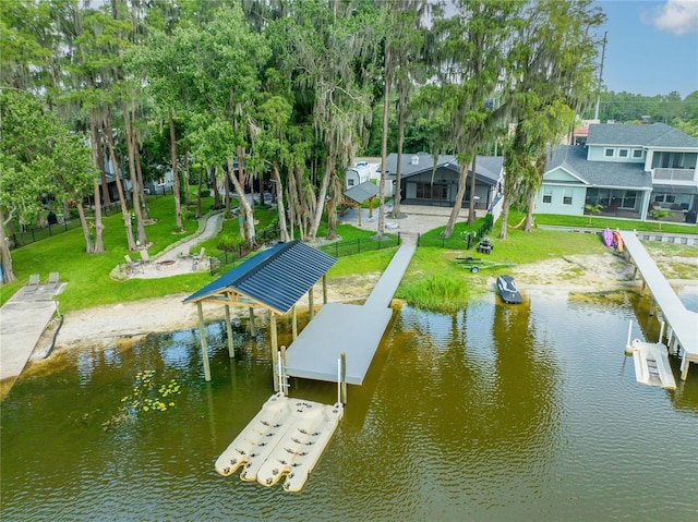 dock area with a yard and a water view