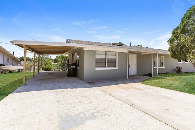 view of front facade with a front lawn and a carport