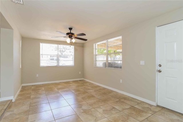 unfurnished room with ceiling fan and light tile patterned floors