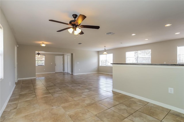 unfurnished room featuring light tile patterned floors and ceiling fan