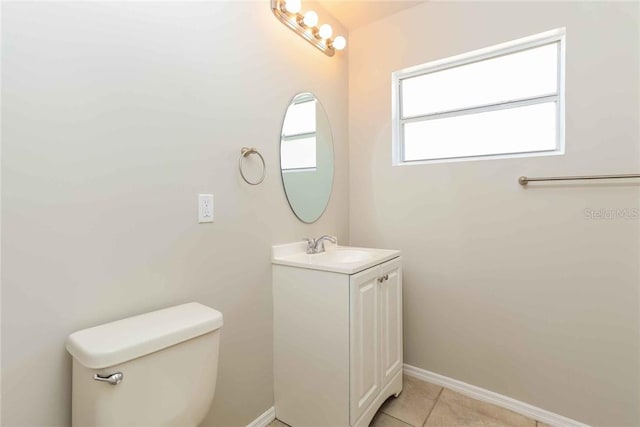 bathroom featuring tile patterned flooring, vanity, and toilet