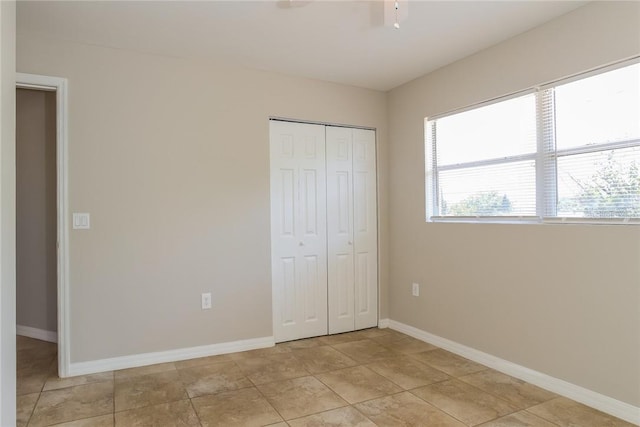 unfurnished bedroom featuring a closet and light tile patterned floors