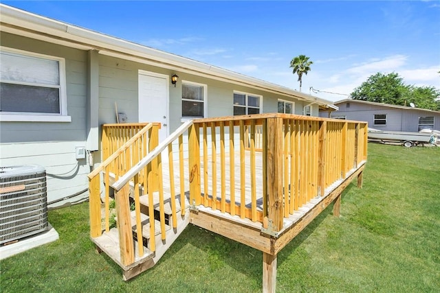 wooden deck featuring central AC unit and a lawn