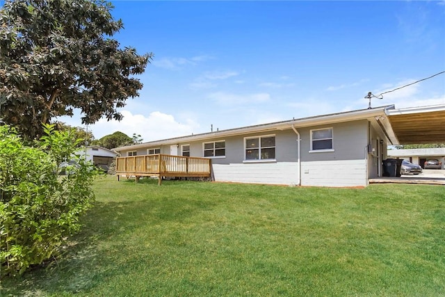 rear view of property with a deck and a yard