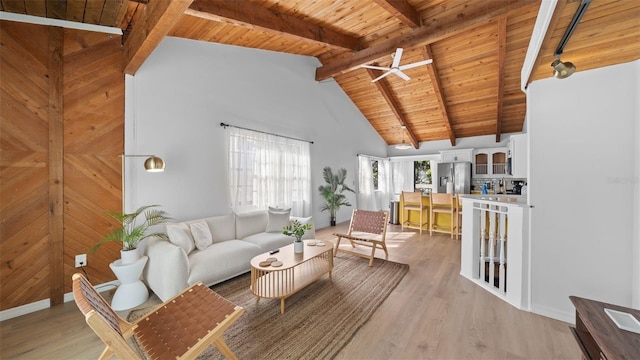 living room featuring beamed ceiling, light wood-type flooring, and wood ceiling