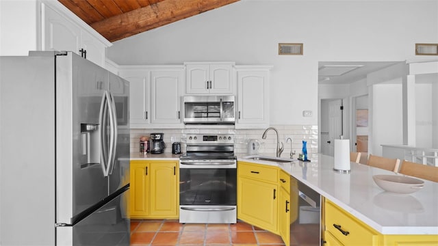 kitchen with sink, vaulted ceiling, decorative backsplash, wood ceiling, and stainless steel appliances