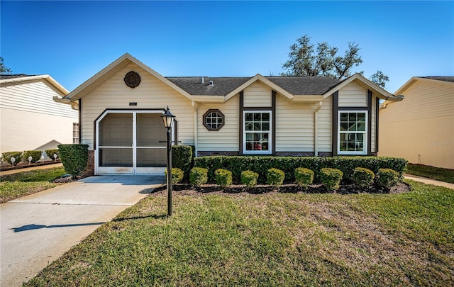 ranch-style house with a front yard and a garage