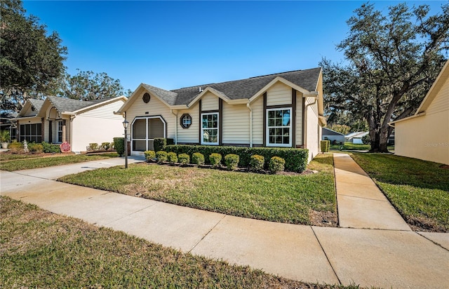 single story home featuring a front yard and a garage