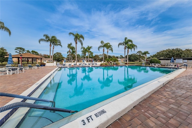 view of swimming pool featuring a gazebo and a patio area