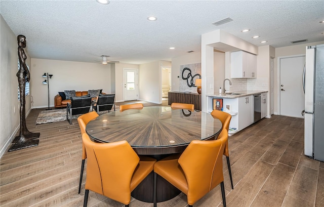 dining area with a textured ceiling and sink