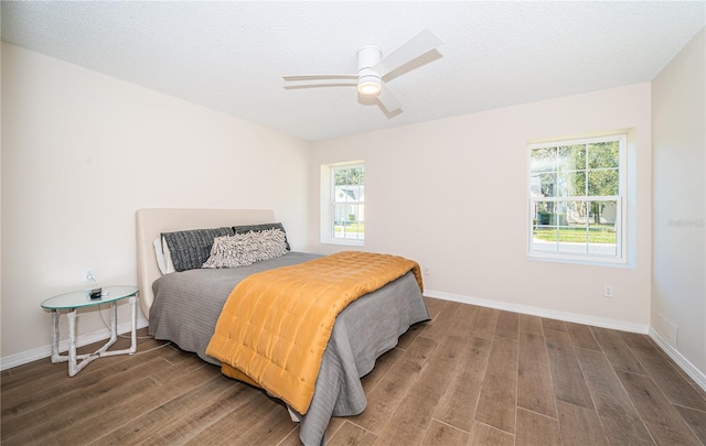 bedroom featuring hardwood / wood-style floors, ceiling fan, and a textured ceiling