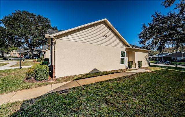 view of side of property with a lawn