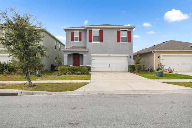 front of property featuring central AC unit and a garage