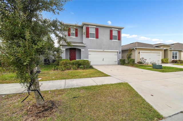 view of front of house with cooling unit, a front lawn, and a garage