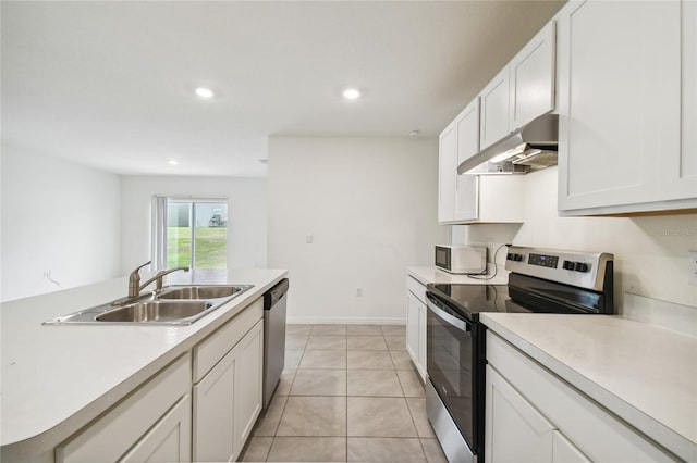 kitchen with white cabinets, stainless steel appliances, light tile patterned flooring, and sink