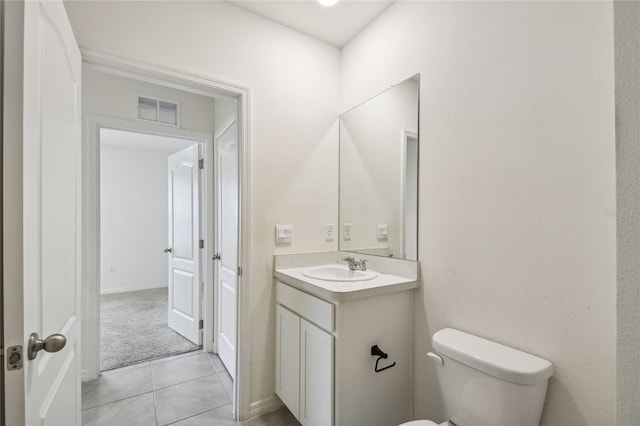 bathroom featuring vanity, toilet, and tile patterned floors