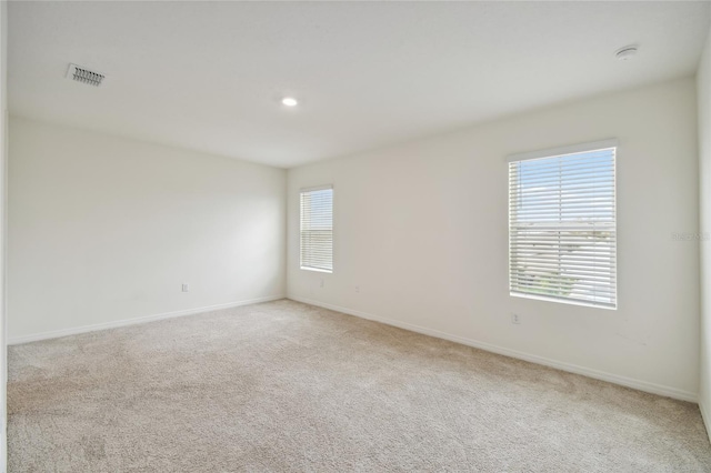 spare room with light colored carpet