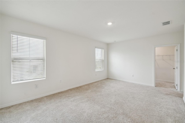 carpeted empty room with a wealth of natural light