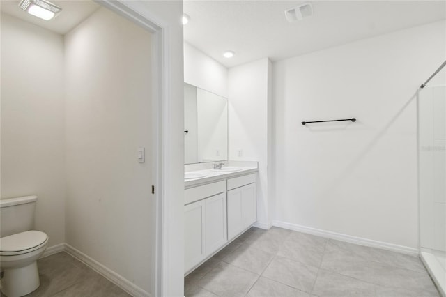 bathroom featuring toilet, tile patterned floors, and vanity