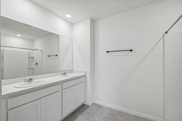 bathroom featuring a shower, vanity, and tile patterned flooring