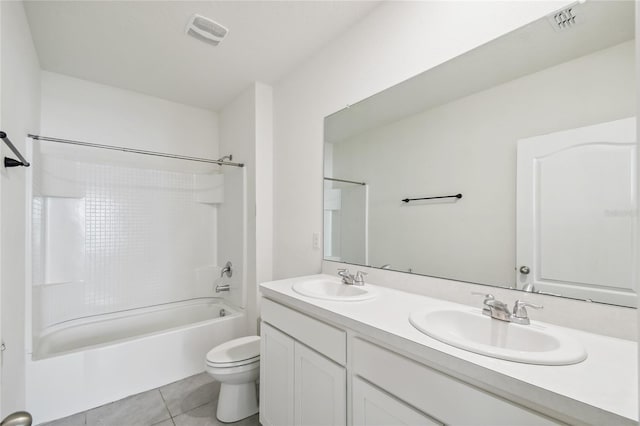 full bathroom featuring washtub / shower combination, vanity, toilet, and tile patterned flooring