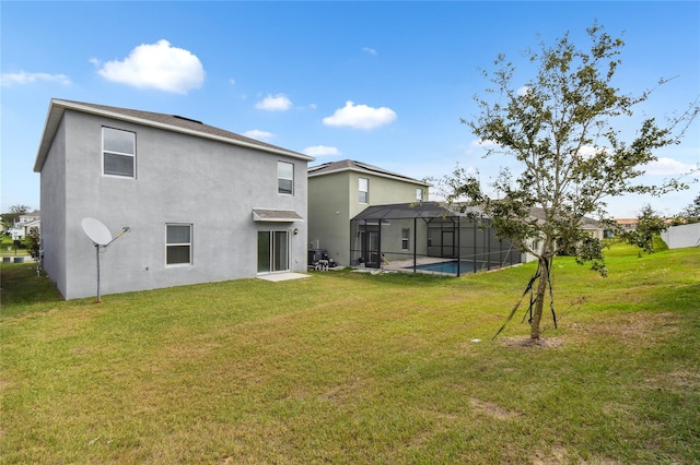 back of house with glass enclosure, a fenced in pool, and a lawn