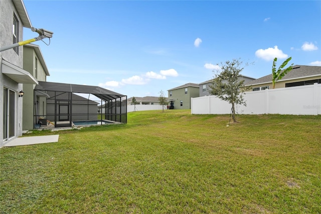 view of yard featuring a fenced in pool and a lanai