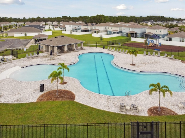 view of swimming pool with a yard, a playground, and a patio