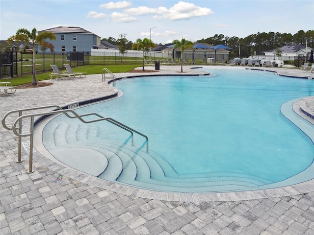 view of pool featuring a lawn and a patio