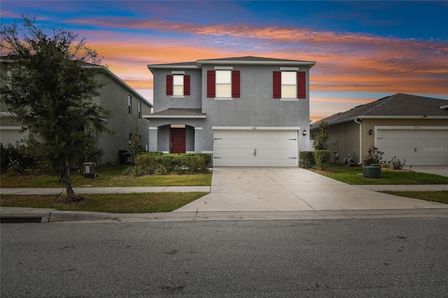 front of property featuring a garage and central air condition unit