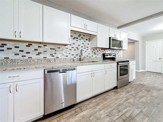 kitchen with white cabinetry and appliances with stainless steel finishes