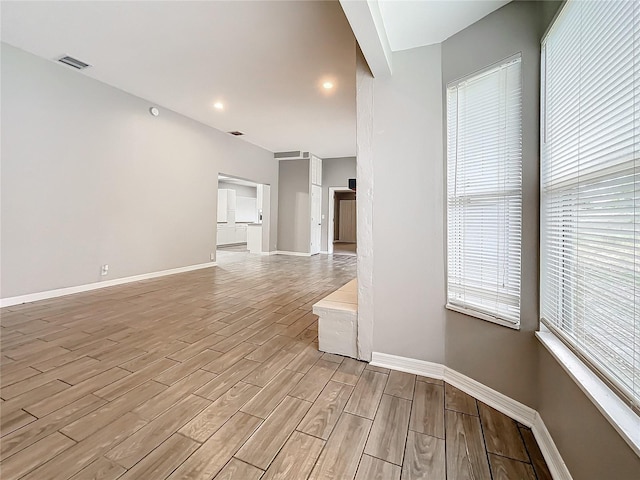 spare room featuring light hardwood / wood-style floors and a healthy amount of sunlight