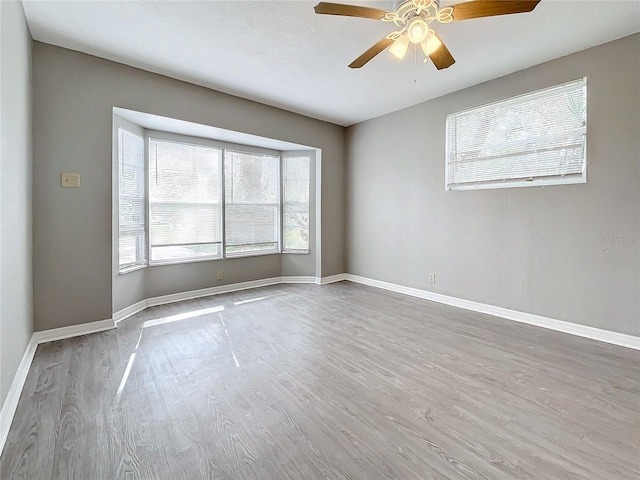 unfurnished room with wood-type flooring and ceiling fan