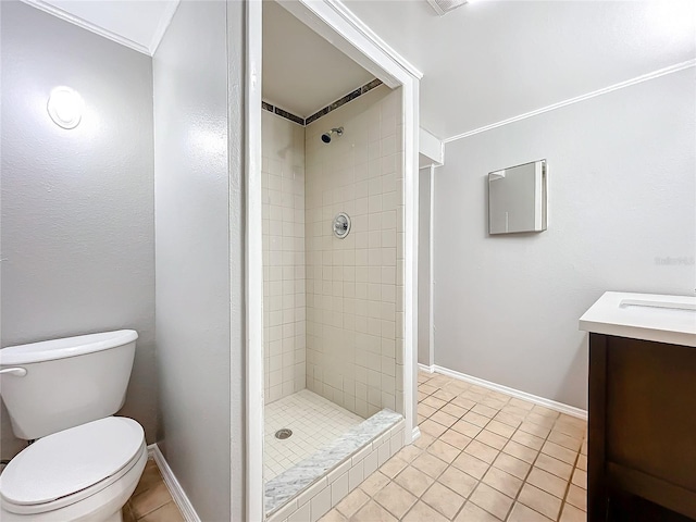 bathroom featuring tile patterned floors, toilet, tiled shower, and ornamental molding