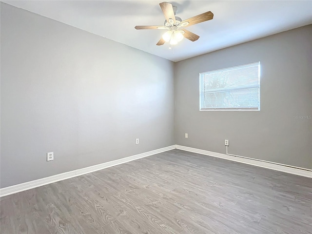 empty room featuring ceiling fan and wood-type flooring